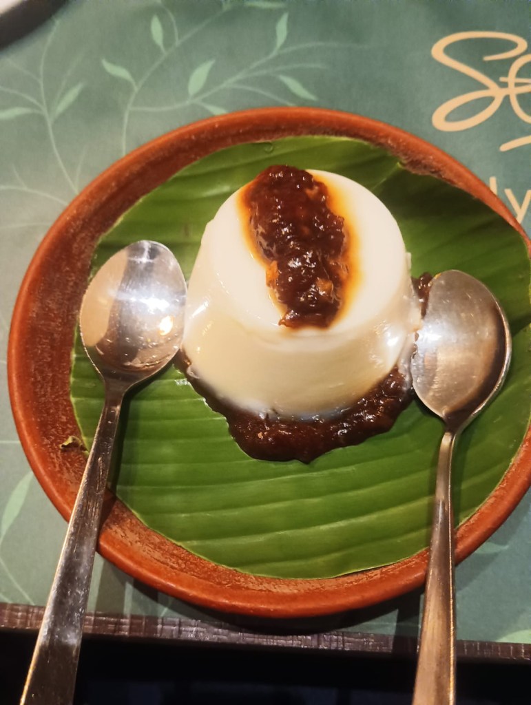 “Traditional tender coconut pudding topped with Panjamritham served on a banana leaf plate.”