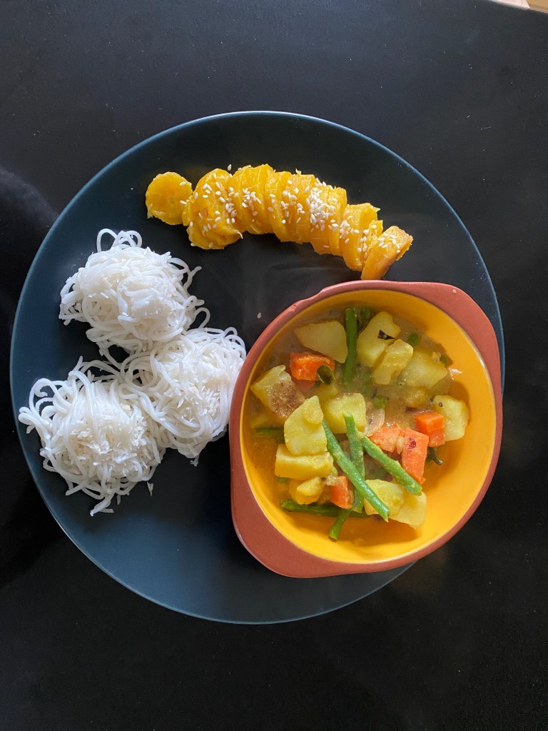 South Indian breakfast with idiyappam, vegetable stew and steamed plantain with sesame seeds